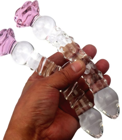 Clear crystal premium glass dildo with a flared base and smooth contoured body displayed on a luxury silk backdrop for intimate couple wellness.