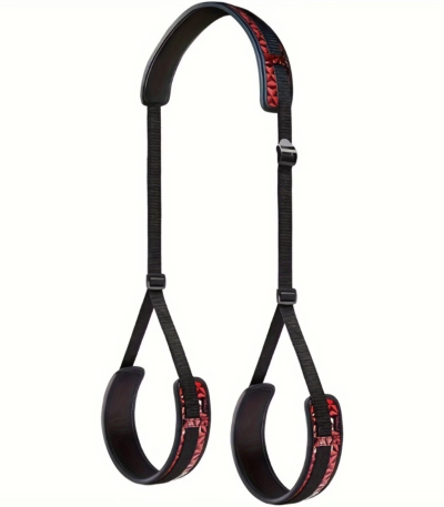 Premium black couples gear set including adjustable wrist and ankle restraint cuffs with soft fabric lining and connected leg restraint straps displayed on a bed.