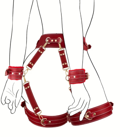 Six piece black adjustable restraint kit including wrist and ankle cuffs with soft plush lining, a blindfold, and cross waist straps arranged on a bed.