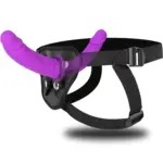 Purple double-ended silicone massager with a black adjustable waist strap on a clean background.